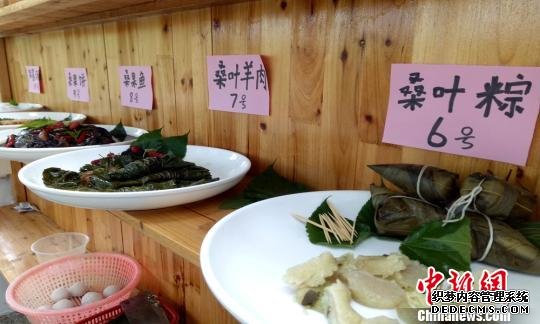 “大厨”们的巧手烹饪和制作的桑叶粽子、桑叶羊肉、桑果鱼等美食。　钟学满　摄