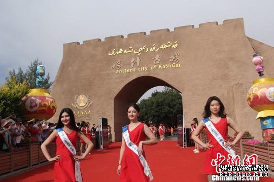 从线上和线下评选入围新疆总决赛的50位佳丽，参加了中国5A级景区喀什古城的开城仪式，现场走秀展示。　朱景朝 摄