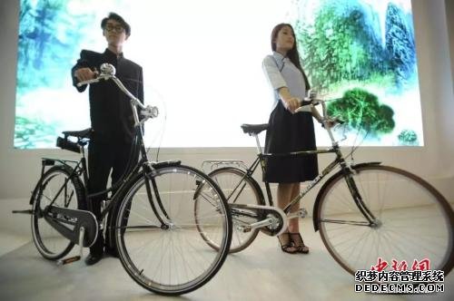 模特展示复刻版的新中国第一辆国产“飞鸽1950”自行车(左一)，它的旁边，则是1989年作为“国礼”送给时任美国总统老布什访华礼物的复刻车(右一)。图片来源：/p中新网